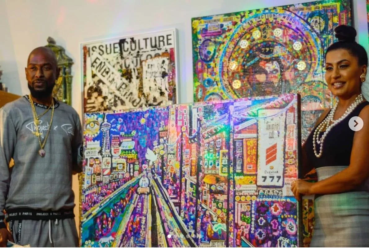 Two people presenting The Day of Transcendence at an indoor art event