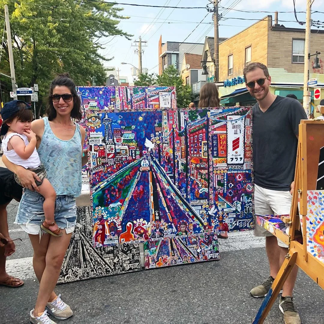 People with The Day of Transcendence on a Toronto street beside an art display